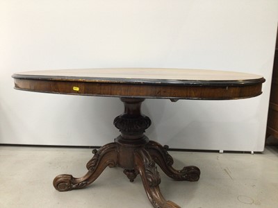Lot 143 - Nineteenth century rosewood oval tilt top loo table on carved turned column and four carved splayed legs with scroll feet, 130cm x 99cm x 67cm high and a set of four dining chairs
