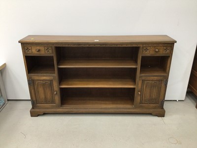 Lot 146 - Old Charm narrow low bookcase with central shelves flanked by single drawer and cupboards