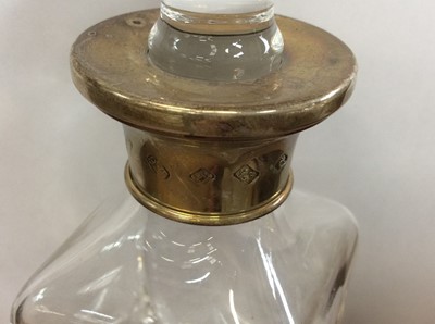 Lot 15 - Silver mounted tapered glass spirit decanter, together with a silver gilt mounted glass scent bottle (2)