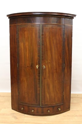 Lot 1434 - George III mahogany and rosewood crossbanded bowfront corner cabinet