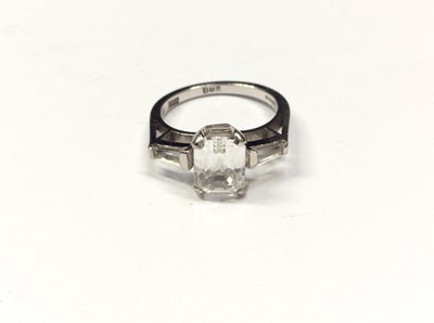 Lot 599 - Art Deco style 18ct white gold ring with a synthetic white step-cut stone and tapered baguette cut shoulders