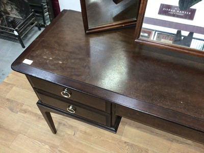 Lot 80 - Stag Minstrel bedroom suite comprising two double wardrobes, chest of three short and four long drawers, pair of single drawer bedside tables and a dressing table with triple mirror back and five d...