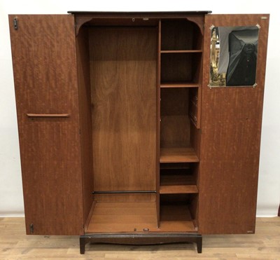 Lot 80 - Stag Minstrel bedroom suite comprising two double wardrobes, chest of three short and four long drawers, pair of single drawer bedside tables and a dressing table with triple mirror back and five d...