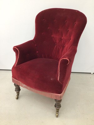 Lot 198 - Victorian spoon back armchair with buttoned red upholstery on turned mahogany front legs and brass capped castors