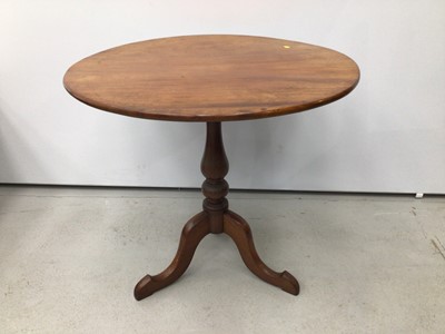 Lot 199 - Nineteenth century mahogany wine table with circular tilt top on turned column and three hipped splayed legs, 78cm diameter, 70cm high