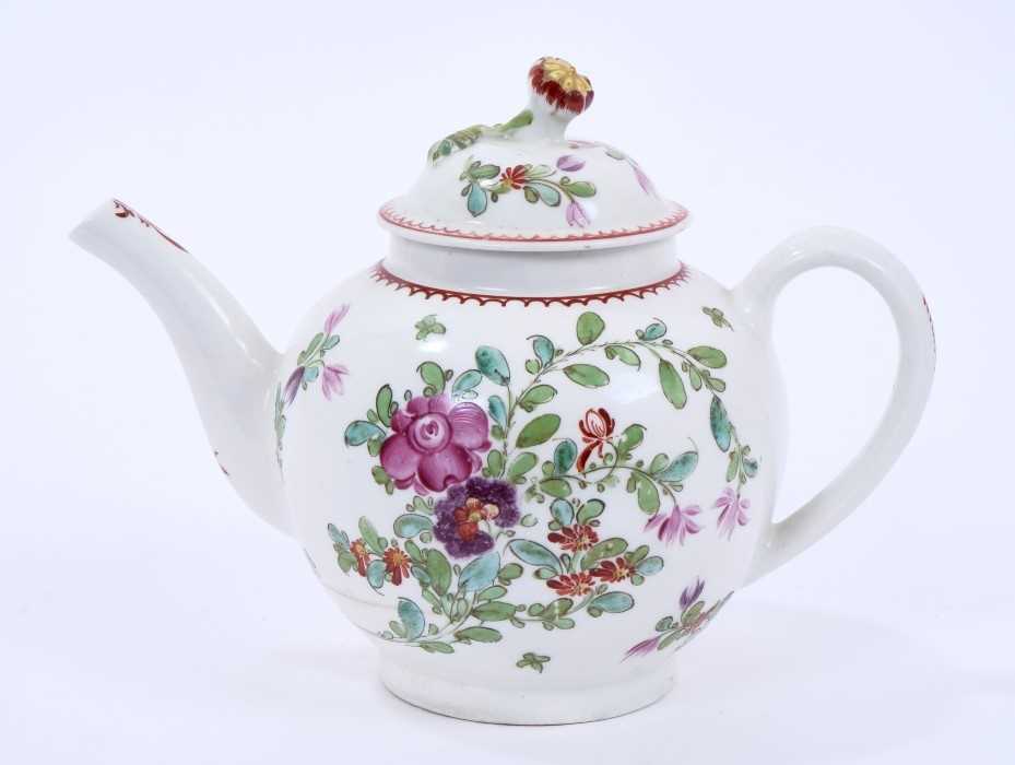 Lot 68 - Lowestoft teapot and cover, of globular form with a flower finial and curved spout, painted in Curtis style with flowers within a red line and loop border, 14cm high