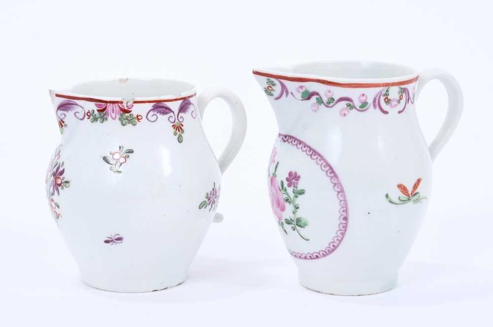 Lot 70 - Two Lowestoft sparrow beak jugs, both painted in the Curtis style with flowers, the first with a puce panel below the spout