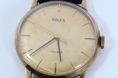 Lot 552 - A gentleman's 9ct gold vintage Rolex wristwatch with circular dial and baton numbers, the back of the case numbered 433230, on black leather strap with Rolex buckle