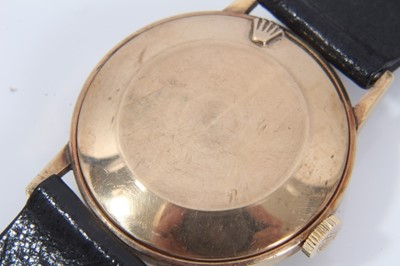 Lot 552 - A gentleman's 9ct gold vintage Rolex wristwatch with circular dial and baton numbers, the back of the case numbered 433230, on black leather strap with Rolex buckle