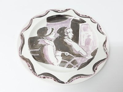 Lot 78 - Unusual Wedgwood Etruria plate, lustre painted in black and purple with a picture of two men, one sat behind the other, watching a figure through a window or door, stamped mark and inscribed initia...