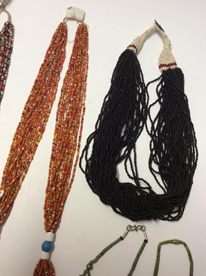 Lot 343 - Two Bondo Tribe micro bead necklaces, other similar style African necklaces and beads