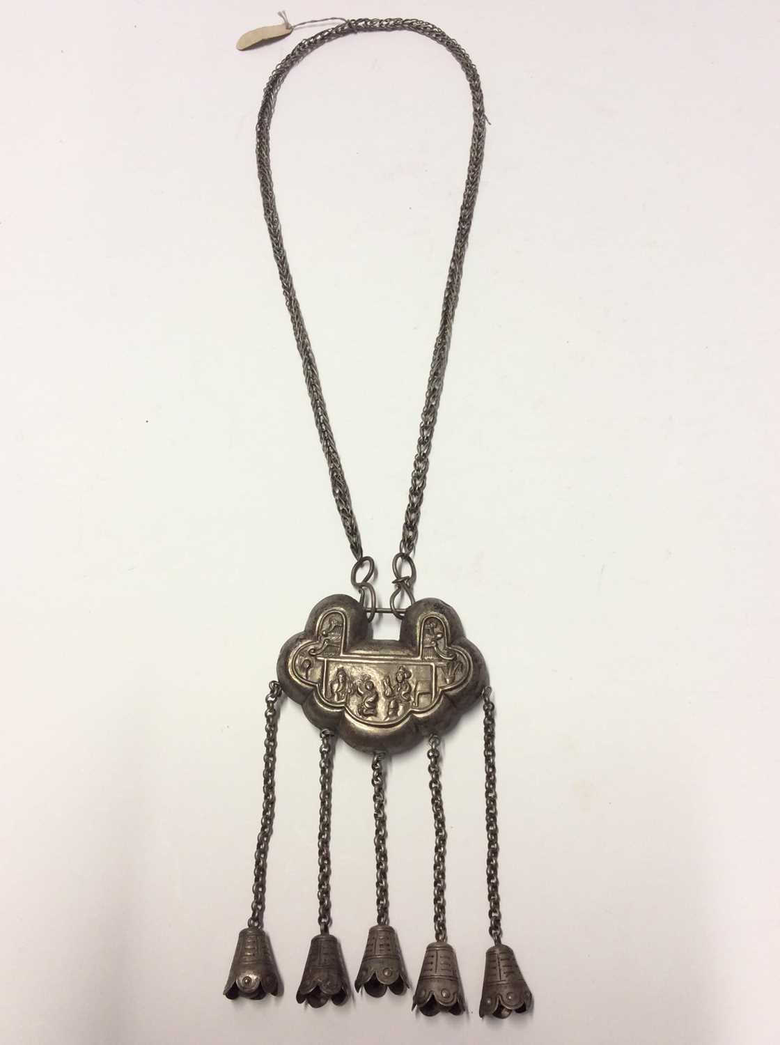 Lot 344 - Old Chinese white metal necklace with embossed panel depicting figures and Chinese characters, with bells on chain