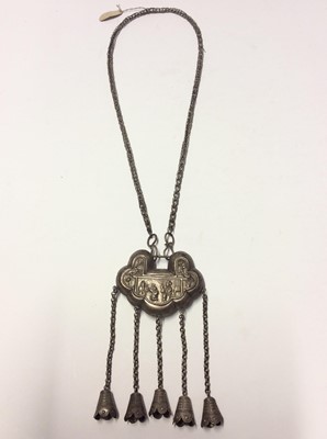 Lot 591 - Old Chinese white metal necklace with embossed panel depicting figures and Chinese characters, with bells on chain