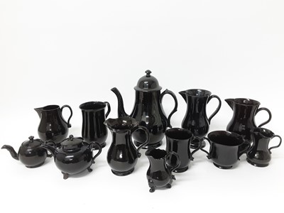 Lot 86 - Collection of Jackfield-type pottery, 18th and 19th century, including coffee pot, teapots, jugs and mugs, one with worn decoration but the rest plain (12 pieces)