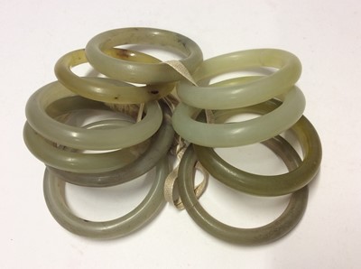 Lot 593 - Group ten jade/green hard stone polished bangles