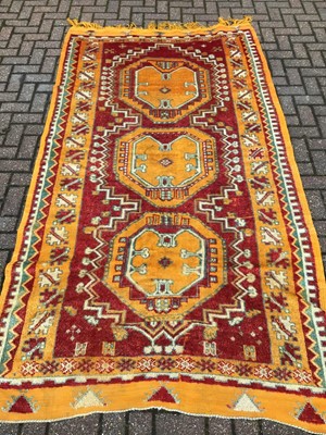 Lot 223 - Eastern rug with geometric decoration on orange, red, blue and cream ground, 266cm x 150cm