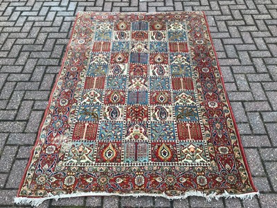 Lot 224 - Eastern rug with geometric decoration on red and blue ground, 200cm x 139cm