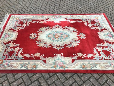 Lot 225 - Chinese wash rug with floral decoration on red and cream ground, 277cm x 182cm