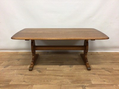 Lot 185 - Ercol elm coffee table with rounded rectangular top on end standards joined by stretcher H51cm L130cm D70cm