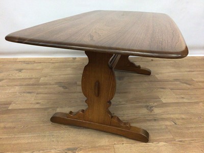 Lot 185 - Ercol elm coffee table with rounded rectangular top on end standards joined by stretcher H51cm L130cm D70cm