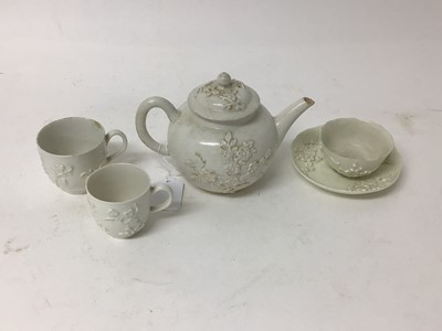 Lot 94 - Bow blanc de chine porcelain, c.1750s, including a teapot, tea bowl and saucer, and two coffee cups, with raised floral decoration, the teapot measuring 11.5cm high