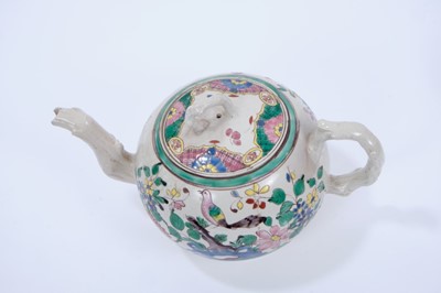 Lot 95 - Staffordshire salt-glazed teapot, c.1750, brightly enamelled on both sides with a tropical bird perched on rockwork, the cover with alternating patterned panels, with crabstock handle, spout and kn...