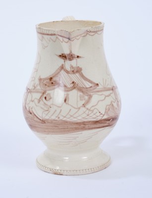 Lot 98 - Late 18th century Creamware pottery jug, the double strap handle issuing from flower and leaf terminals, raised on a pedestal foot with beadwork borders to foot and rim, painted in sepia with a Chi...