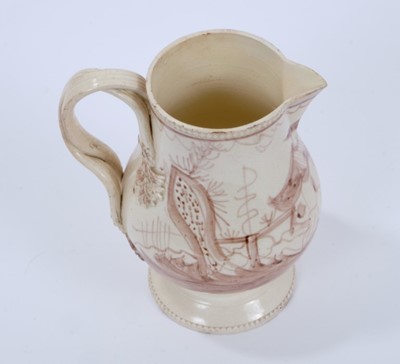 Lot 98 - Late 18th century Creamware pottery jug, the double strap handle issuing from flower and leaf terminals, raised on a pedestal foot with beadwork borders to foot and rim, painted in sepia with a Chi...