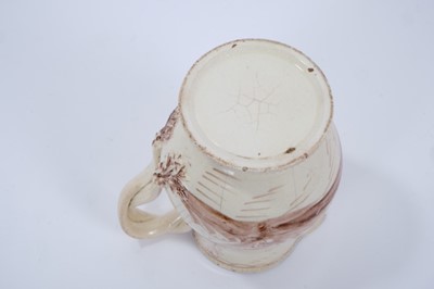 Lot 98 - Late 18th century Creamware pottery jug, the double strap handle issuing from flower and leaf terminals, raised on a pedestal foot with beadwork borders to foot and rim, painted in sepia with a Chi...