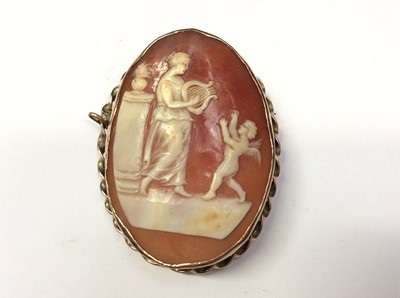 Lot 602 - 19th century carved shell oval cameo depicting a classical woman playing a lyre to a cherub, in yellow metal brooch mount, 55mm x 40mm
