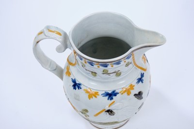 Lot 101 - Prattware pottery jug, c.1800, decorated in relief with a continuous scene representing the nursery rhyme Old Mother Slipper Slopper, 18.5cm high