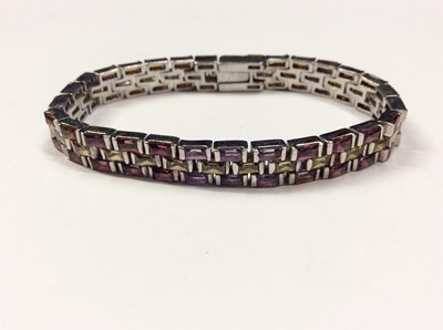 Lot 608 - Multi gem set bracelet with synthetic orange, pink, purple and yellow rectangular stones in white metal setting, 18cm long