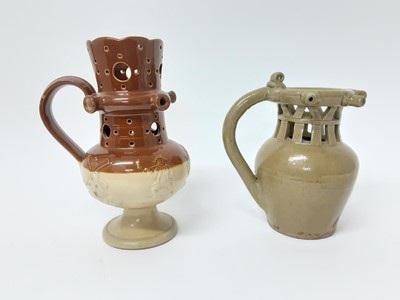Lot 112 - Two salt glazed stoneware puzzle jugs, one in Doulton style and the other plain, both unmarked, 21.5cm and 18.5cm high