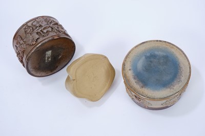 Lot 113 - Three 19th century stoneware inkwells, the first of mask form, 6.5cm long, and the other two salt glazed, of circular form with sprigged decoration, 7.25cm and 8.25cm diameter