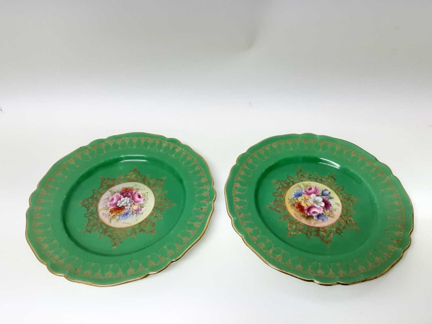 Lot 240 - Set of twelve good quality Royal Worcester plates with handpainted floral decoration on green and gilt ground, all signed Stanley, 23cm diameter