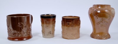 Lot 120 - Salt glazed pottery stoneware, including a beaker with sterling silver mounted rim, a tobacco or snuff jar with portrait of a woman taking snuff, blank cartouche above, and two tankard with hunting...