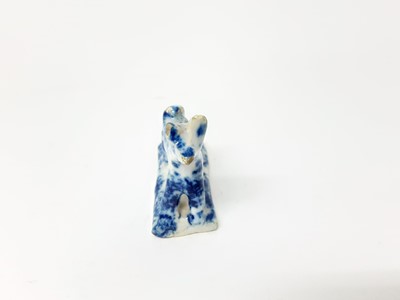 Lot 128 - 19th century English pottery whistle in the form of a dog, with blue sponge ware decoration, 5.25cm high