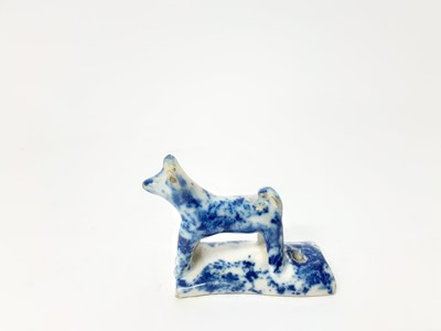 Lot 128 - 19th century English pottery whistle in the form of a dog, with blue sponge ware decoration, 5.25cm high