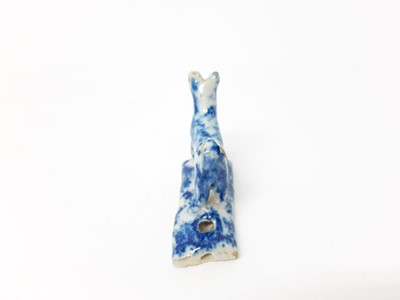 Lot 128 - 19th century English pottery whistle in the form of a dog, with blue sponge ware decoration, 5.25cm high