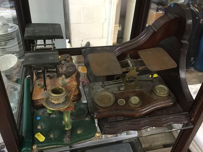 Lot 530 - Two pairs of late Victorian brass letter scales with a collection of weights, together with a mahogany wall bracket and a candlestick in the form of a monkey (4)