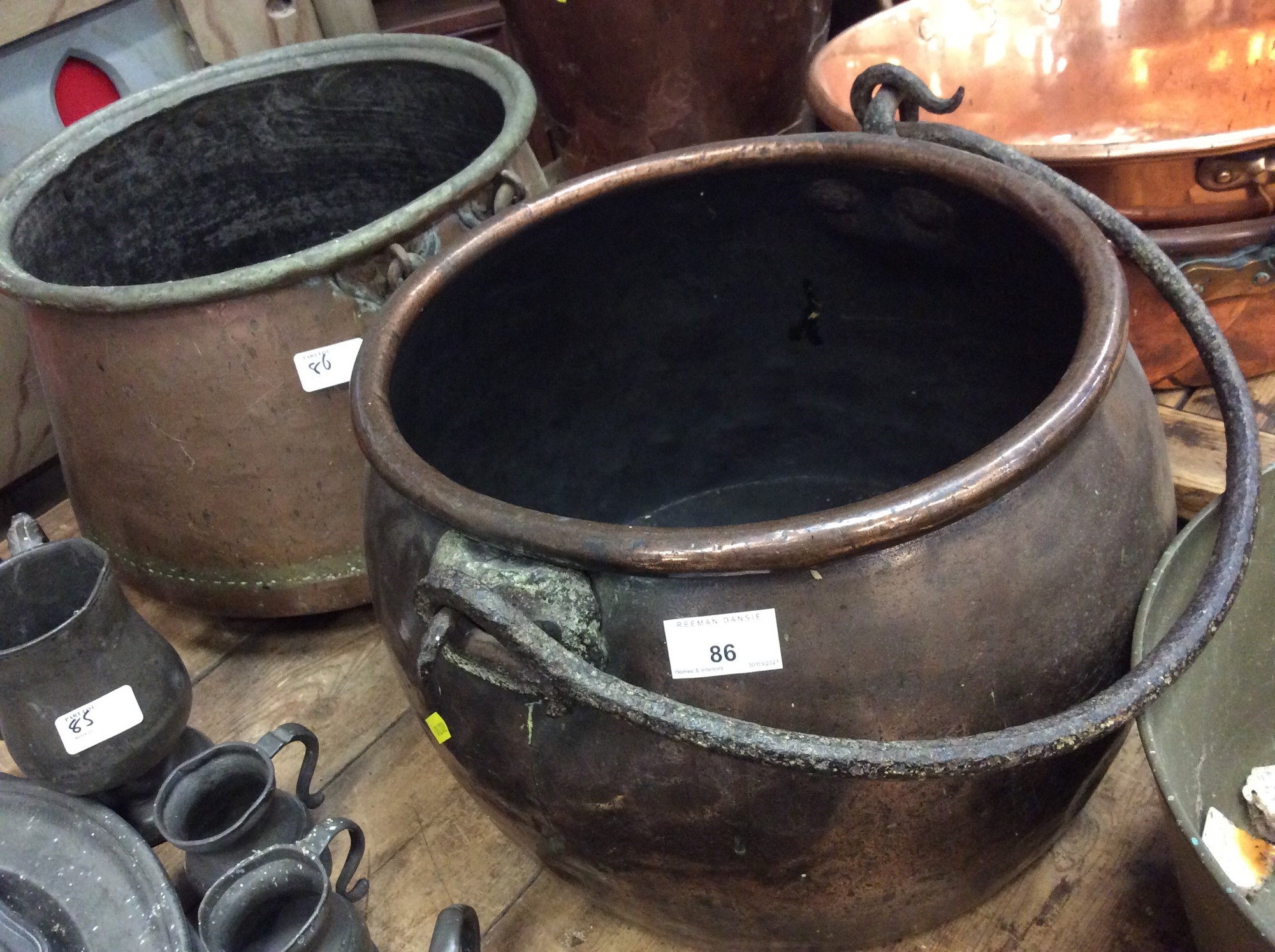 Lot 86 Two antique copper cauldrons with swing