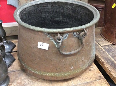 Lot 86 - Two antique copper cauldrons with swing handles together with a brass cauldron (3)