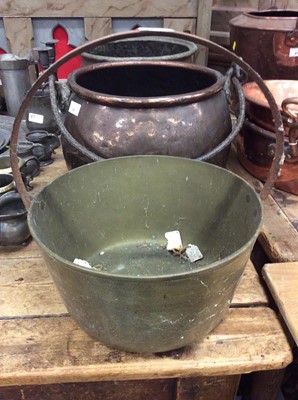 Lot 86 - Two antique copper cauldrons with swing handles together with a brass cauldron (3)