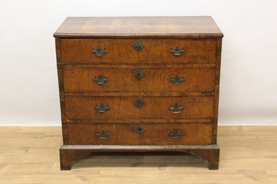 Lot 1421 - Early 18th century walnut chest of four long drawers with brass handles