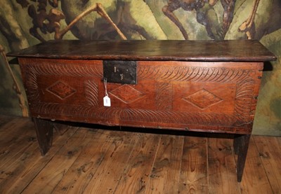 Lot 1503 - 17th century oak six plank coffer, plank top with moulded edge and geometric carved front on high V-cut ends, 114cm wide x 40cm deep x 59cm high