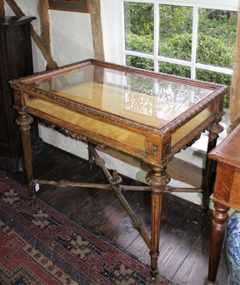 Lot 1508 - Fine quality 19th century Continental carved and gilded walnut bijouterie table, with hinged glazed top and sides, heavily carved with acanthus and boss ornament on turned fluted legs united by an...