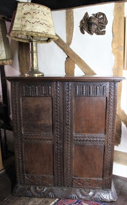 Lot 1510 - Carved oak hall cupboard, with shelved interior enclosed by pair of carved panelled doors on similar base, 17th century elements, 93cm wide x 38cm deep x 104cm high