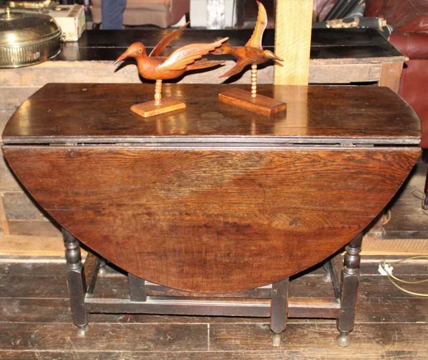 Lot 1511 - Early 18th century oak drop leaf dining table, with oval hinged top over end frieze drawer on turned and block understructure, 122cm x 149cm