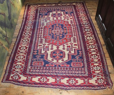 Lot 1521 - Eastern rug, with cream field centred by concentric medallion within multiple borders with tassel ends, 224 x 144cm together with Persian rug with powder blue ground, 230 x 125cm