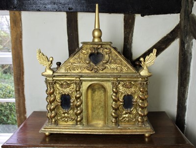 Lot 1522 - Antique Italian giltwood reliquary, of ark form, the hinged cover with central finial and glazed window and cartouche mouldings, the front wit/ twin glazed panels and split spindle ornament, 68cm w...